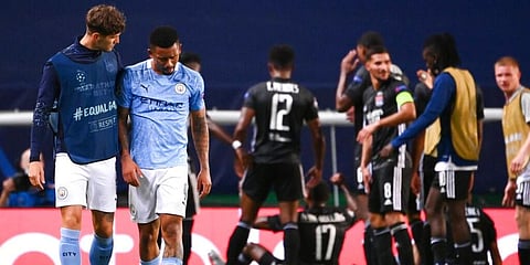 Manchester City's Gabriel Jesus is consoled by teammate John Stones after their loss in the Champions League quarterfinal match against Lyon. (Photo | AP)