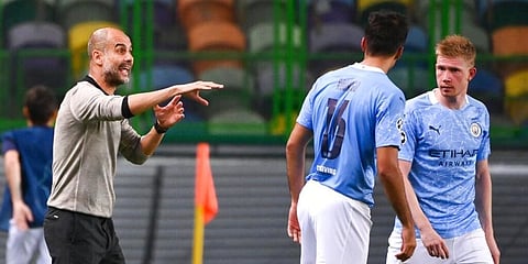 Manchester City head coach Pep Guardiola give instructions to Rodrigo and Kevin De Bruyne during a match. (Photo | AP)