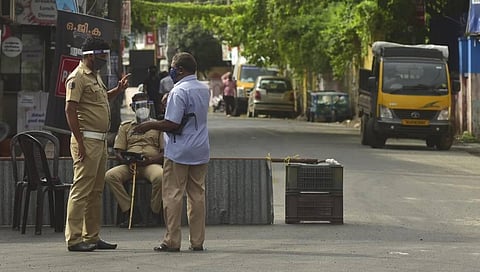 Cops stop a person trying to enter Karukappally area in Kochi after it was declared a containment zone. (Photo | Albin Mathew, EPS)