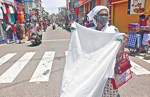 Lockdown has been lifted in Thiruvananthapuram city but trade and businesses have not picked up. A towel vendor desperately looks for customers on the otherwise busy road passing through the East Fort