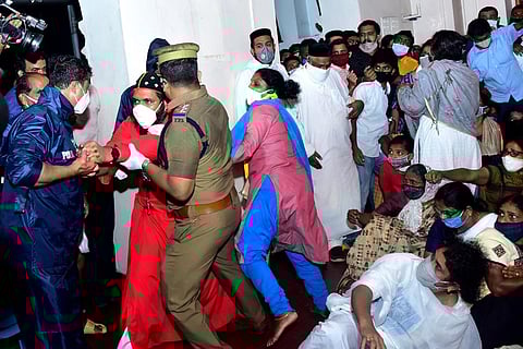 Police officials in uniform and in PPE kits arrest and remove bishops and faithful protesting at the Mulanthuruthy Marthoman Church on Monday | Express