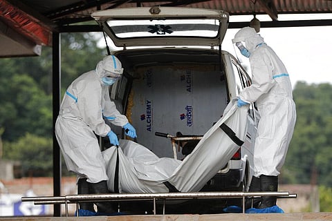 Nepalese army personnel unload from a hearse van, the dead body of a person who died of COVID-19 for cremation in Kathmandu, Nepal. (Photo | AP)