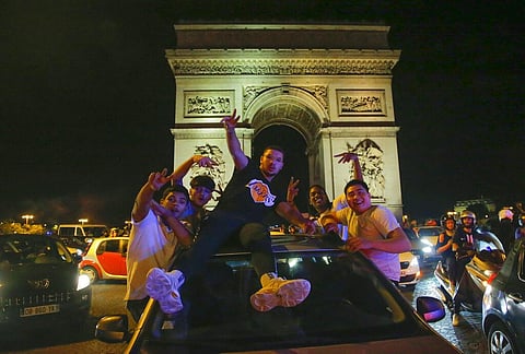 Supporters of the Paris Saint Germain soccer team celebrates on the Champs Elysee in Paris, Tuesday, Aug. 18, 2020 after his team won 3-0 against RB Leipzig. (Photo | AP)