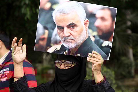 An Indian woman holding placards protest against American President Donald Trump against the killing of Iranian military commander Qasem Soleimani near the US Embassy in New Delhi. (Photo | ANI)