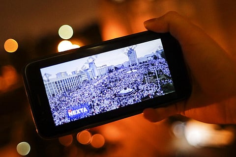A man looks at Telegram channel NEXTA Live on his smartphone in Minsk, Belarus, Wednesday, Aug. 19, 2020. (Photo | AP)