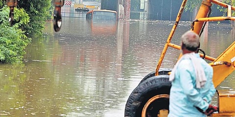 A passenger bus submerged in a flooded underpass at Pul Pehladpur in Southeast Delhi. (Photo | EPS)