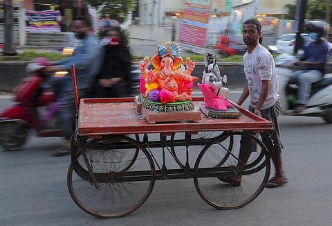 An Indian vendor carries idols of elephant-headed Hindu god Ganesha on a cart for sale during Ganesh Chaturthi festival celebrations in Hyderabad, India, Saturday, Aug. 22, 2020. (Photo | AP)