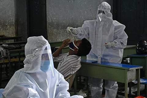 A health worker collects the swab sample for COVID testing. (Photo | Prasant Madugula, EPS)