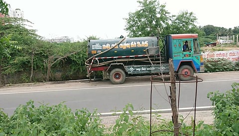 A private tanker discharging sewage into a storm water drain alongside Porur Link Road