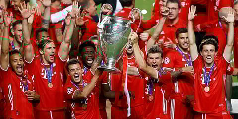 Bayern Munich players lift the trophy after they won the Champions League final against PSG at the Luz stadium in Lisbon. (Photo | AP)