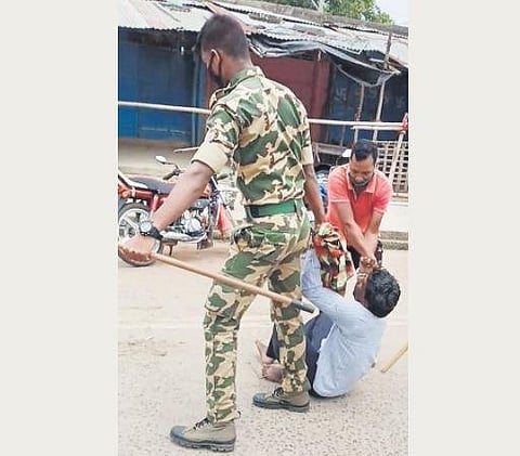 An agitator being dragged by police personnel from the protest site