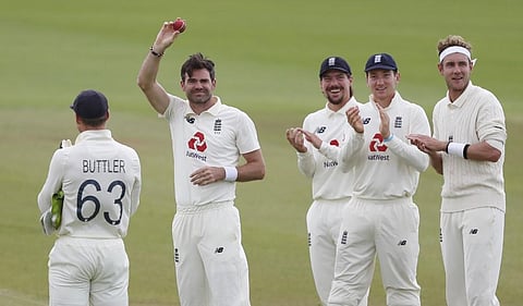 England's James Anderson (2nd L) shows the ball as he is applauded by teammates after taking the wicket of Pakistan's Azhar Ali, his 600th Test match wicket. (Photo | AFP)