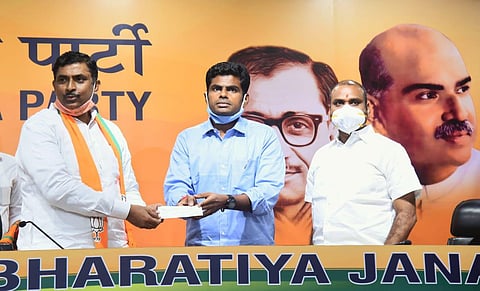 Former IPS officer K Annamalai (centre) joins the BJP in the presence of BJP National Gen Secy P Muralidhar Rao and Tamil Nadu BJP State President L Murugan (Express photo | Parveen Negi)