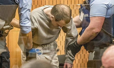 Brenton Harrison Tarrant, 29, is assisted to his seat in the dock on day three at the Christchurch High Court for sentencing. (Photo | AP)