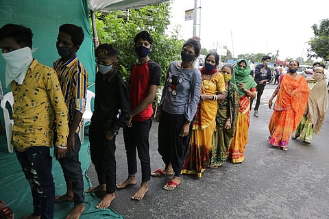 People stand in a queue to test for COVID-19 at a check post erected to screen people coming from outside the city, in Ahmedabad, India, Tuesday, Aug. 25, 2020. (Photo | AP)