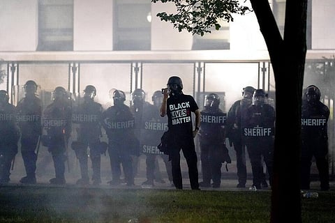 People gather Tuesday, Aug. 25, 2020 to protest in Kenosha, Wis. Anger over the Sunday shooting of Jacob Blake, a Black man, by police spilled into the streets for a third night. (Photo | AP)