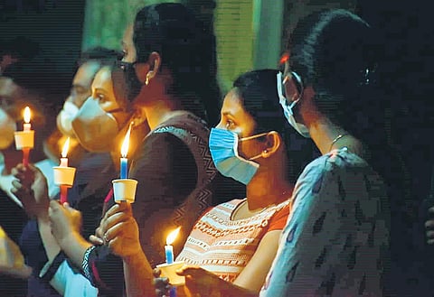 Healthcare professionals hold a candlelight vigil, as a tribute to doctors, nurses, paramedical staff, and others who died of Covid-19, in Hyderabad on Wednesday | S Senbagapandiyan