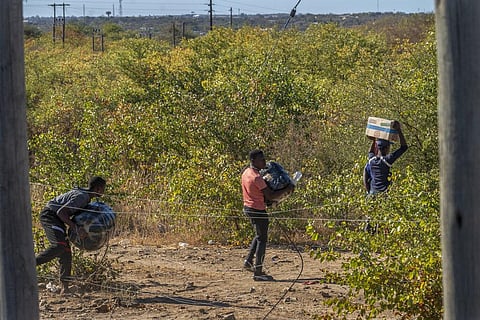 People smuggle goods into Zimbabwe from South Africa near the Beit Bridge border post outside Musina, South Africa (File Photo | AP)