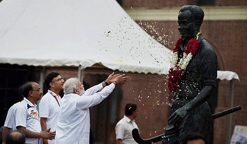 Prime Minister Narendra Modi pays floral tribute to Major Dhyan Chand before flag off