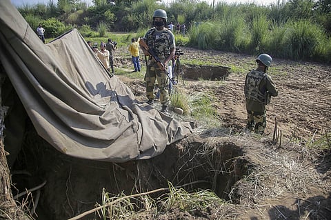 Border Security Force BSF personnel stand near a tunnel originating from Pakistan beneath the Indo-Pak international border fence in J K's Samba district Saturday Aug. 19 2020. (Photo | PTI)
