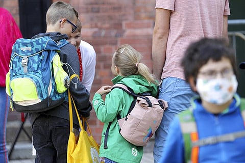 Students are brought to school by their parents in Rostock, Germany Monday. (Photo | AP)