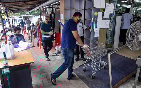 People maintain social distancing as they wait outside grocery shops during total lockdown imposed by the Assam Government to curb the spread of coronavirus in Guwahati Monday July 6 2020. (Photo | PT