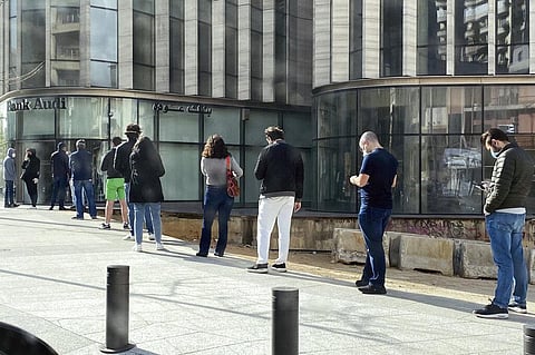 People stand in a line outside a bank in Beirut, Lebanon, amid a financial crisis and a lockdown imposed by the government to help stem the spread of the coronavirus in Lebanon. (File photo | AP)