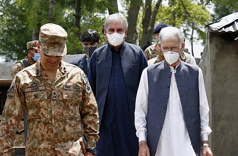 Pakistan's Foreign Minister Shah Mahmood Qureshi, center, Defense Minister Pervez Khattak, right, walk with a senior army officer during their visit to forward area post on Monday. (Photo | AP)