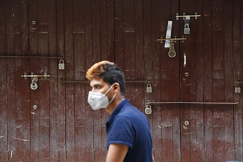 A Nepalese man wearing face mask walks past a closed shop during lockdown in Kathmandu, Nepal, Tuesday, Aug. 25, 2020. (Photo | AP)