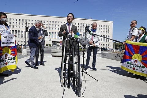 Hong Kong activist Nathan Law takes part in a protest during a meeting of Chinese Foreign Minister Wang Yi with Italian Foreign Minister Luigi Di Maio in Rome (Photo | AP)