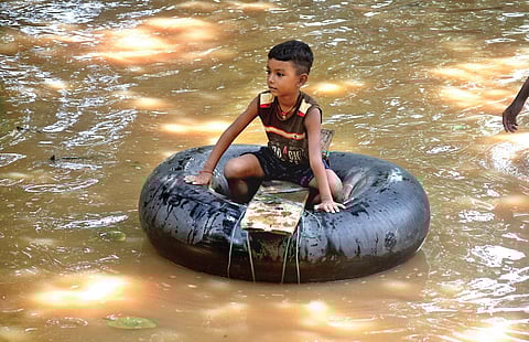 A boy floats on a rubber tube in a village of Rasalpur block under Jajpur district on Sunday | akshya rout