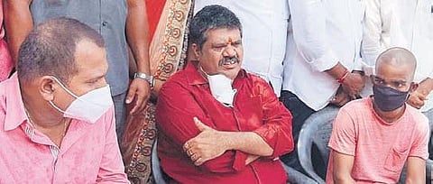 Tourism Minister Muttamsetti Srinivasa Rao, along with tonsuring victim P Srikanth, addressing a media conference in Visakhapatnam on Sunday. (Photo| EPS)