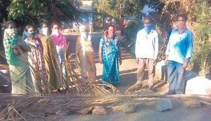 Tribals block the entrance to their hamlet near Hunsur  | Express