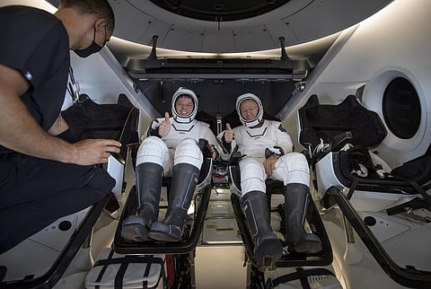 NASA astronauts Robert Behnken, left, and Douglas Hurley are seen inside the SpaceX Crew Dragon Endeavour onboard recovery ship shortly after having landed in the Gulf of Mexico. (Photo | AP)