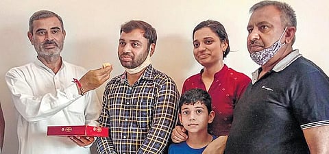 Pradeep Singh is offered sweets by his father-in-law in Sonepat | PTI