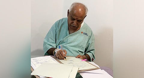 Chief Minister Yediyurappa signs on files from his hospital suite