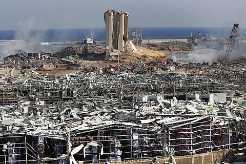 Rescue workers and security officers work at the scene of an explosion that hit the seaport of Beirut, Lebanon (Photo | AP)