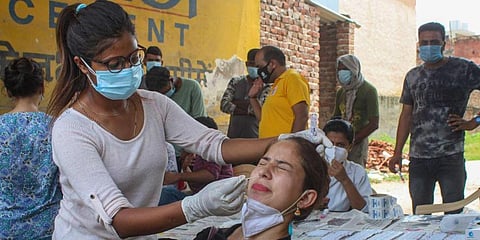 A health worker collects a sample for COVID-19 Real-Time Polymerase Chain Reaction (RT-PCR) test. (Photo | PTI)