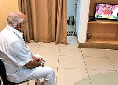 Chief Minister B S Yediyurappa watches the ceremony from his ward at Manipal Hospitals, in Bengaluru on Wednesday 