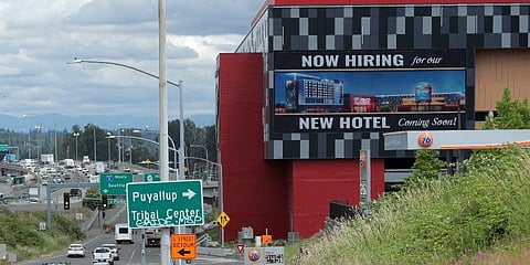 A large video display reads 'Now hiring for our new hotel coming soon!,' at the new Emerald Queen Casino, which is open, and owned by the Puyallup Tribe of Indians, in Tacoma, Wash. (Photo | AP)