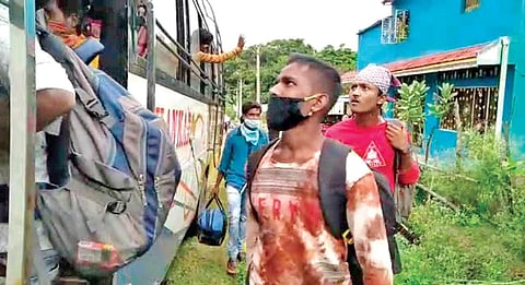 Migrant workers boarding a bus to Karnataka