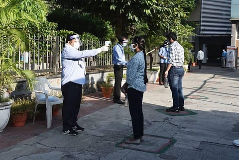 Students being checked for temperature before appearing for the JEE entrance exam at a centre in New Delhi on Tuesday. (Photo | Parveen Negi/EPS)