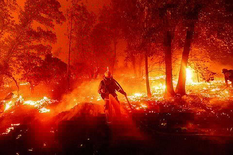 A firefighter battles the Creek Fire as it threatens homes in the Cascadel Woods neighborhood of Madera County, Calif., on Monday, Sept. 7, 2020. (Photo | AP)