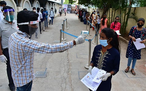 Students stand in queue line to attend a CET At Malkapur (Photo | Vinay Madapu, EPS)