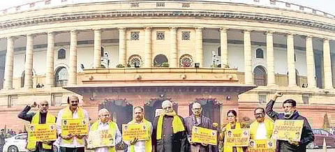 TDP members stage a protest seeking implementation of the AP Reorganisation Act during the winter session of Parliament in New Delhi. (File Photo | PTI)