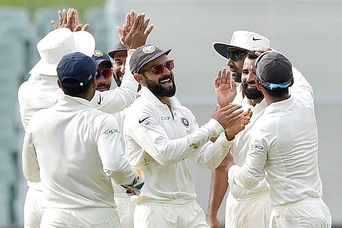 India's captain Virat Kohli (C) celebrates the wicket of Australia's Peter Handscomb with his team during day four of the first Test cricket match at the Adelaide Oval. (Photo | AFP)