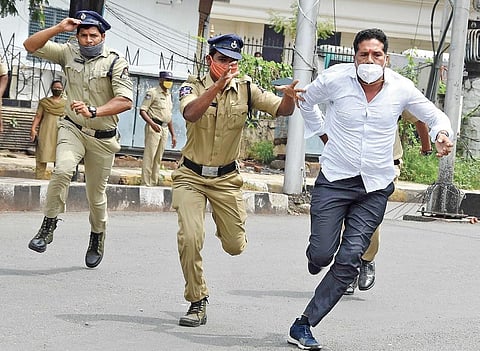Policemen chase a BJP activist during the party’s protest near the Assembly in Hyderabad on Friday | RVK Rao
