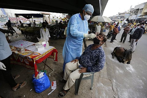 A health worker takes a nasal swab sample to test for COVID-19 in Ahmedabad, India, Friday, Sept. 11, 2020. (Photo | AP)