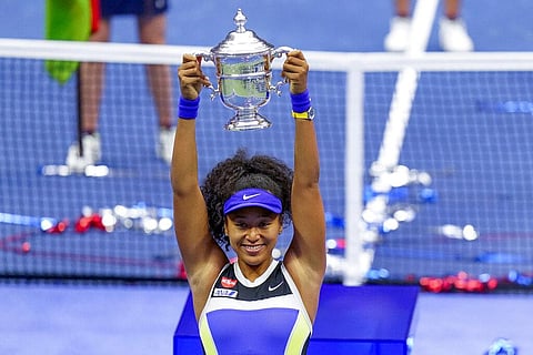 Naomi Osaka, of Japan, holds up the championship trophy after defeating Victoria Azarenka, of Belarus, in the women's singles final of the US Open tennis championships. (Photo | AP)