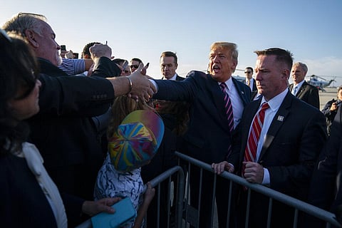 In this Feb. 18, 2020, file photo President Donald Trump greets supporters after arriving at Los Angeles International Airport in Los Angeles. (Photo | AP)